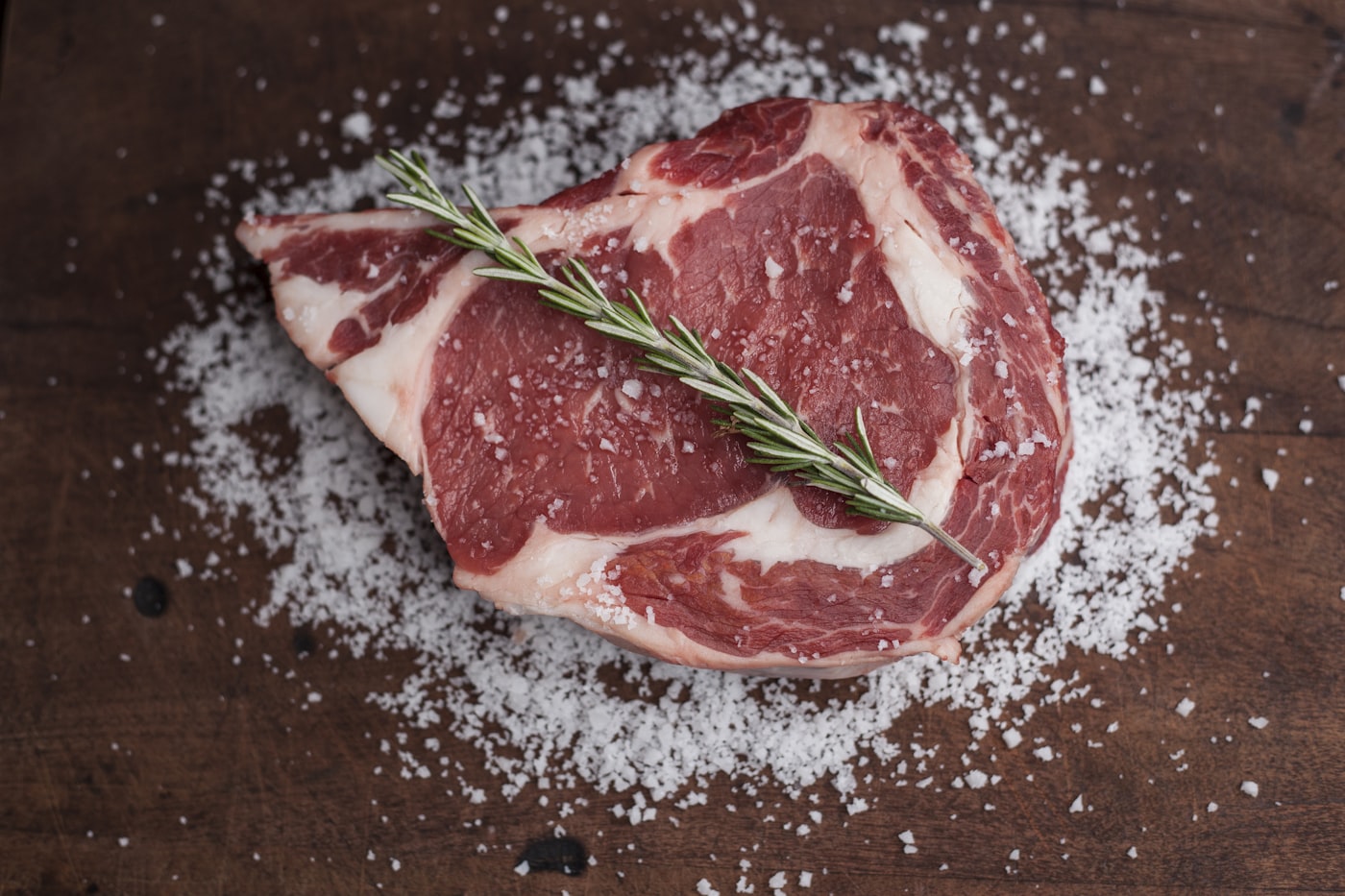 Raw game meat on wooden cutting board